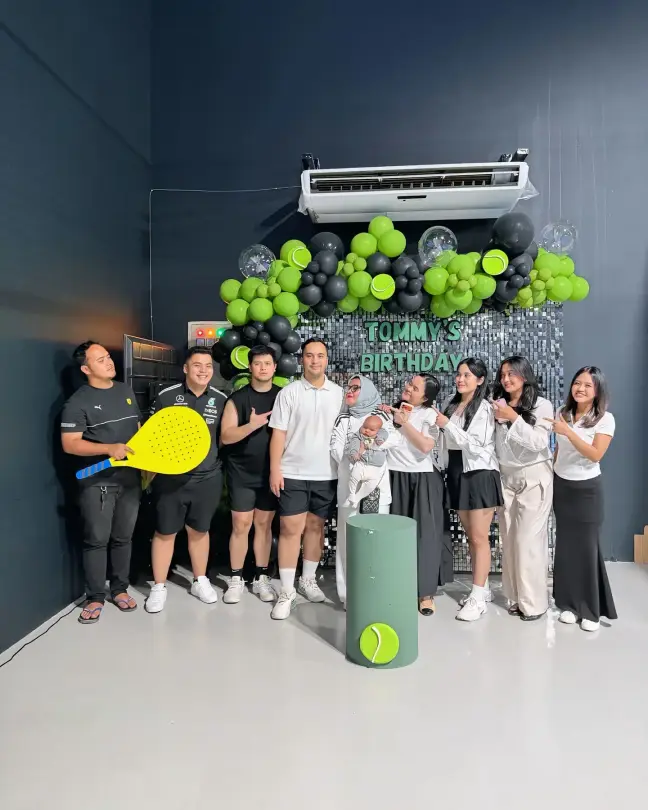 A birthday group celebrating on court