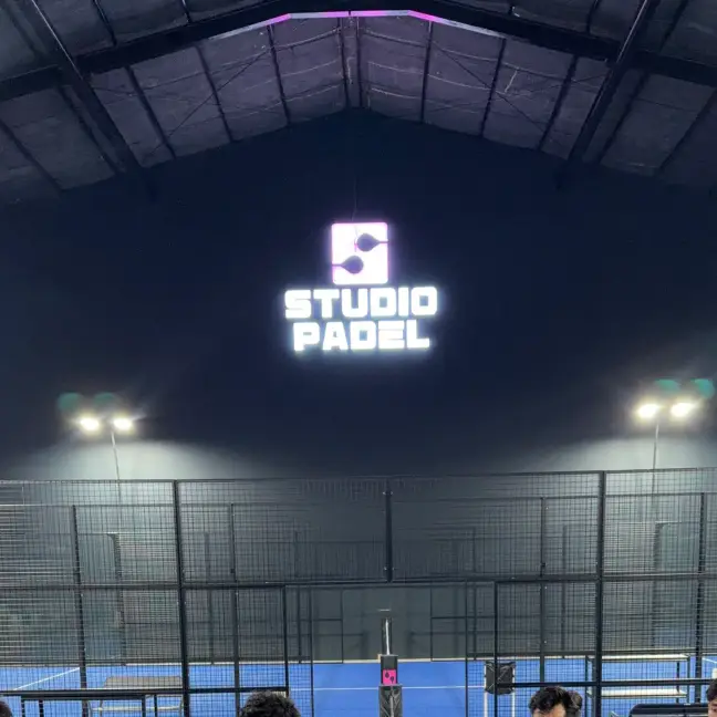 The illuminated Studio Padel sign