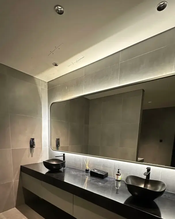 Black stone washbasins with a backlit mirror